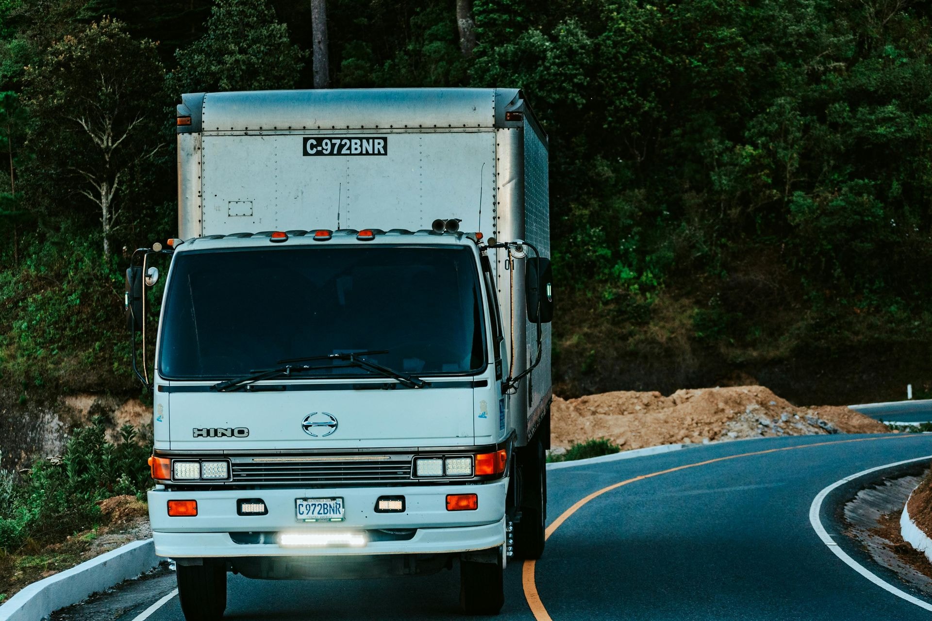 Delivery truck driving on a forest road